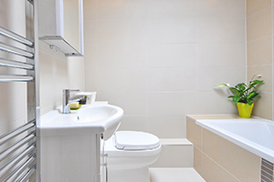 Updating a bathroom includes installing shelf space and painting cabinets